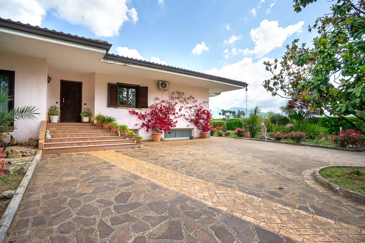 The villa seen from the driveway, with the family dogs